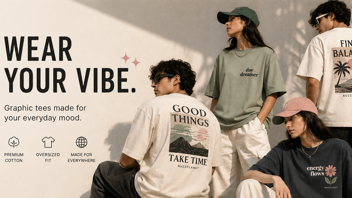Four models wearing graphic t-shirts in a styled outdoor setting with a concrete wall. The shirts feature various designs including a cream graphic with a mountain and the text 'GOOD THINGS TAKE TIME' on the back, a light green t-shirt with 'day dreamer' on the chest, a cream t-shirt with a palm tree graphic reading 'FIND BALANCE' on the back, and a dark navy t-shirt with a floral graphic and 'energy flows' on the front.